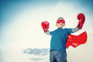 Little boy with boxing gloves outdoors