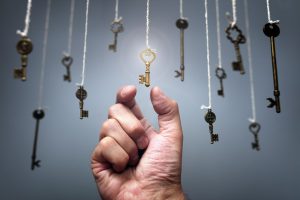 Choosing the key to success from hanging keys concept for aspirations, achievement and incentive