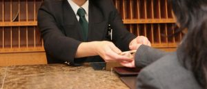 Hotel check-in counter, hand to pass the key to the customer