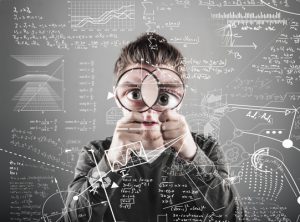 young man look through two magnifying glasses to mathematical formulas and problems.